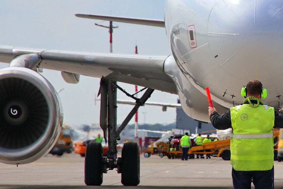 Vorfeldmitarbeiter beim Einweisen eines Flugzeuges mit Gehörschutz | © Linz Airport