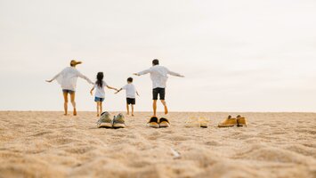 Familie von hinten am Strand | © Envato Elements